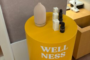 Yellow table with a wellness sign, displayed at the Raw Lilly event