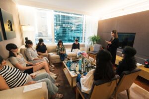 A diverse group of people sitting together in a living room, participating in a lively discussion and social interaction